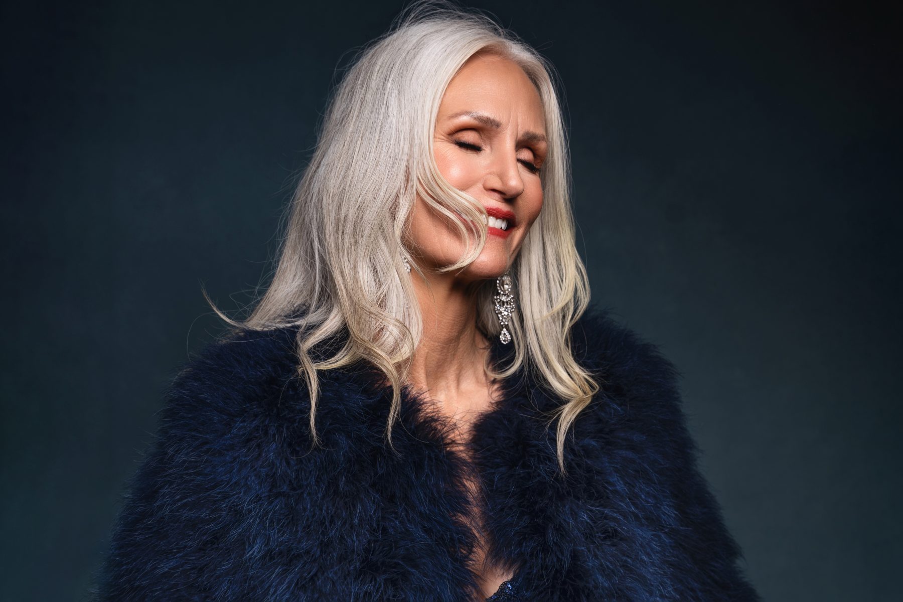 Branding portrait of a woman in a navy feather coat